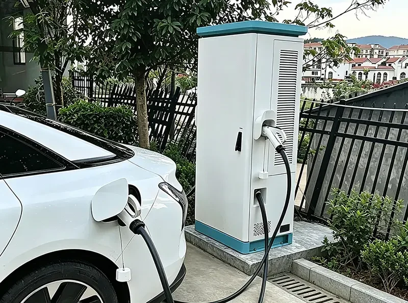 Outdoor residential scene of electric car charging with floor-mounted home EV charger